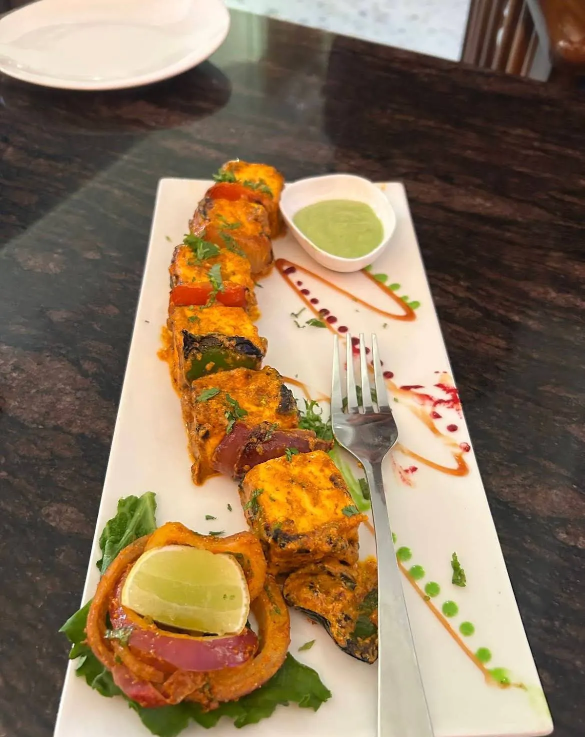 Grilled paneer tikka skewer plated at Eilly Rooftop Revelry