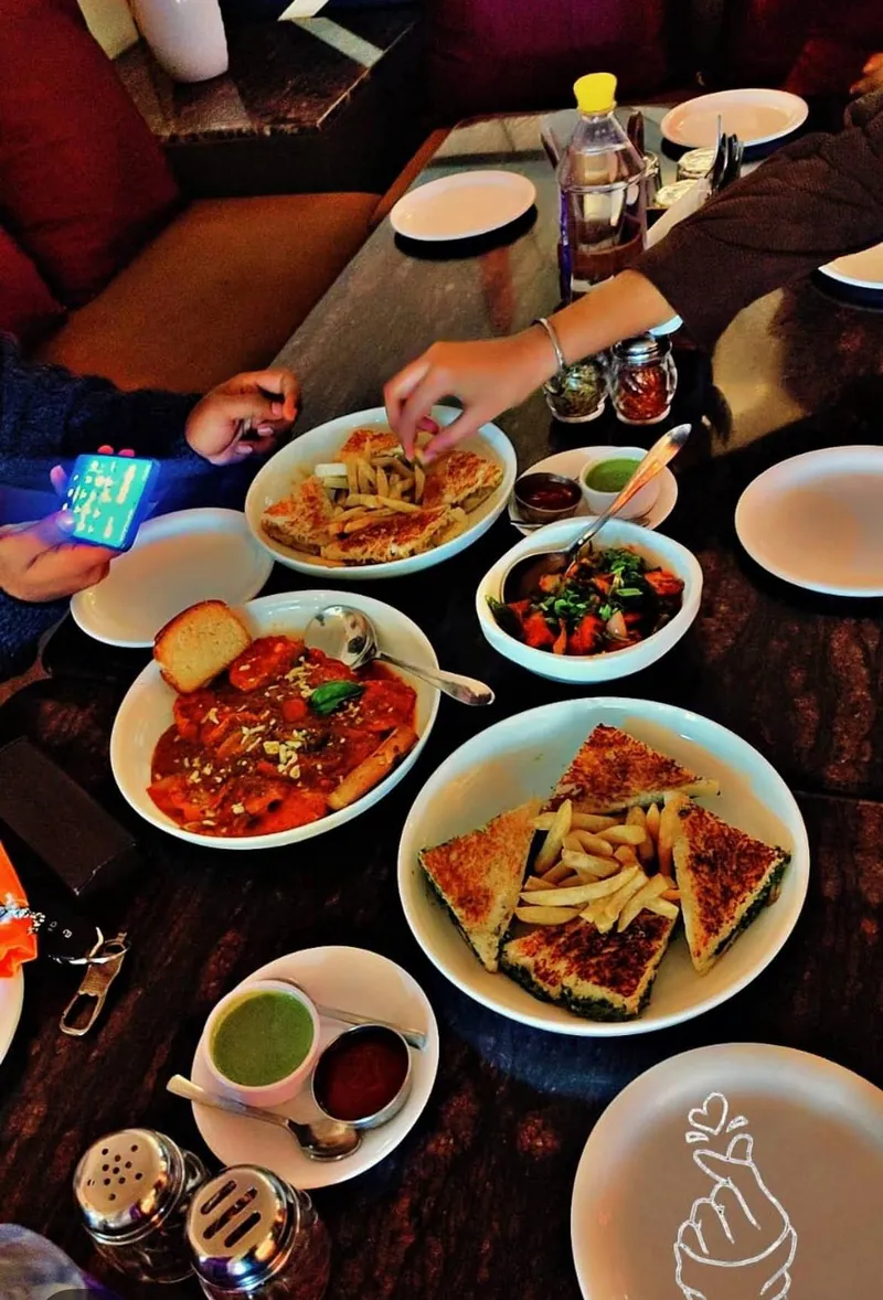 A shared spread of sandwiches, fries and pasta at Eilly Rooftop Revelry